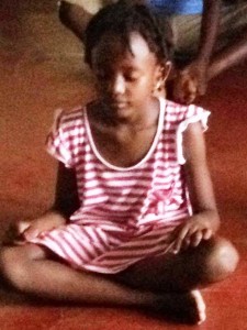 African Girl Meditating during her first martial arts class